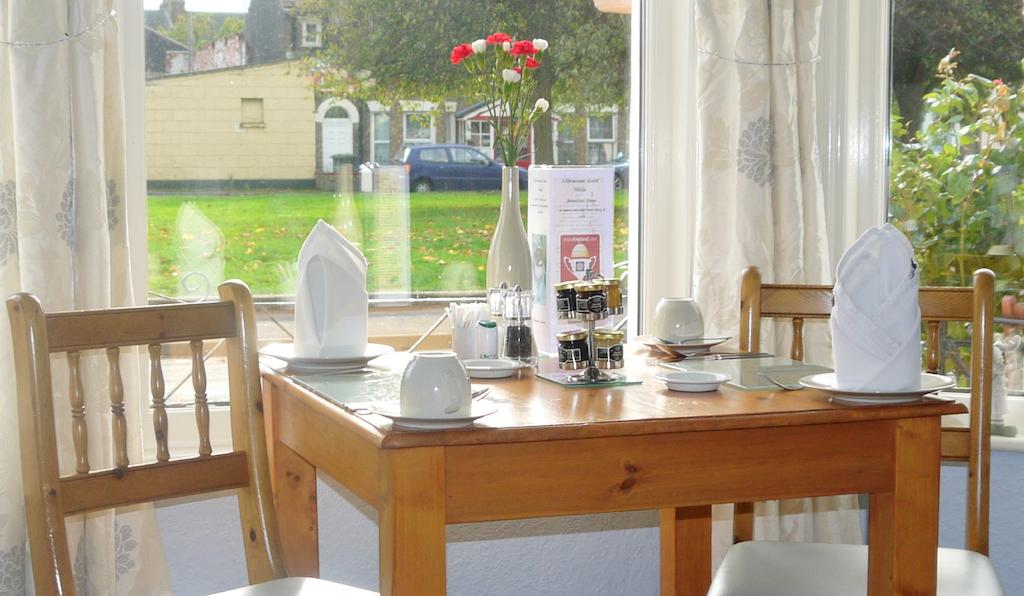 photo of the two chairs and a table against the window set up for breakfast